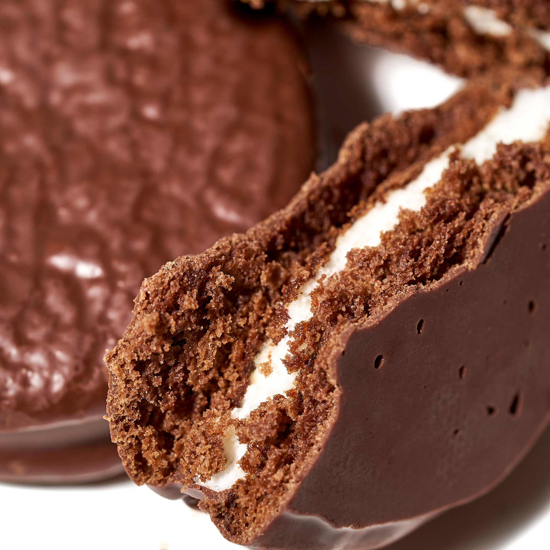 A close up of a Lotte Choco Pie: Cacao Dark Chocolate (12 pieces) cookie.