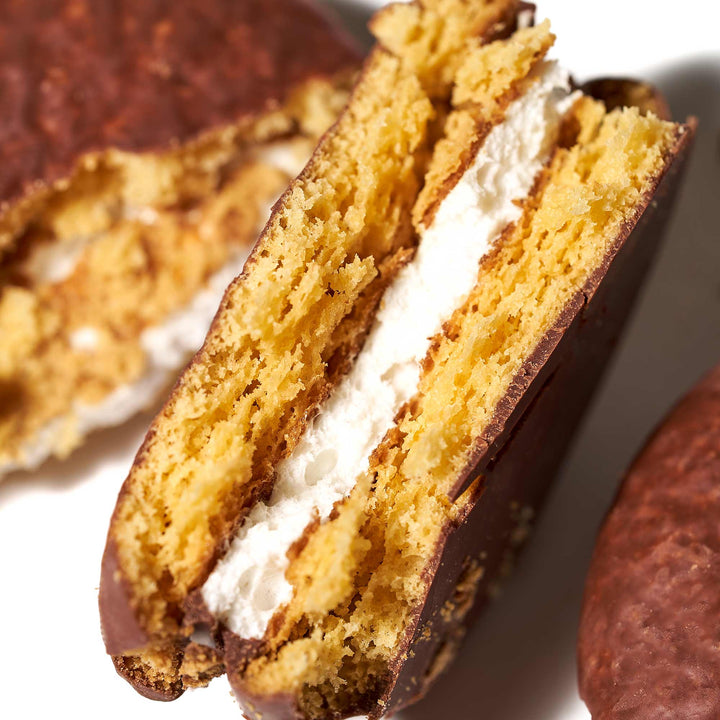 A close up of a Lotte Choco Pie: Banana (12 pieces) with whipped cream sandwich.