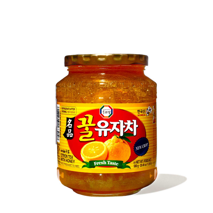A jar of Surasang Yuzu Citron Tea with Honey on a white background.