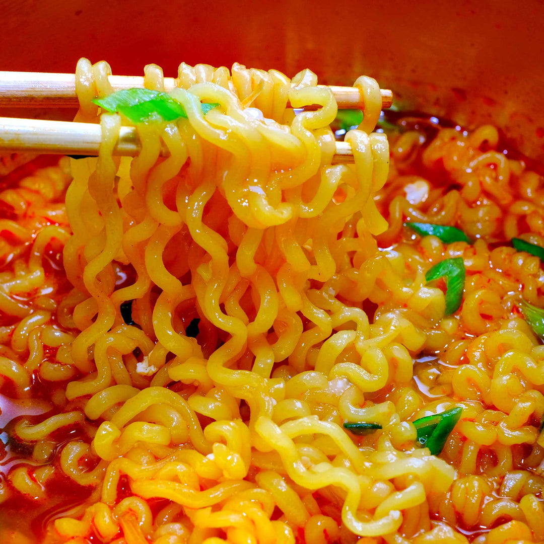 A bowl of Nongshim Shin Ramyun Spicy Ramen (4-pack) with chopsticks in it.