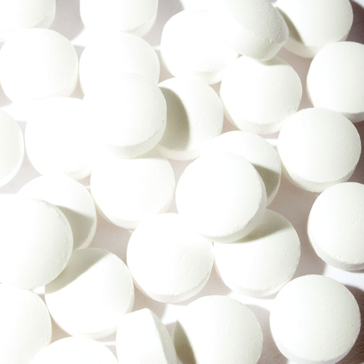A pile of Morinaga Otsubu Ramune Candy pills on a white surface.