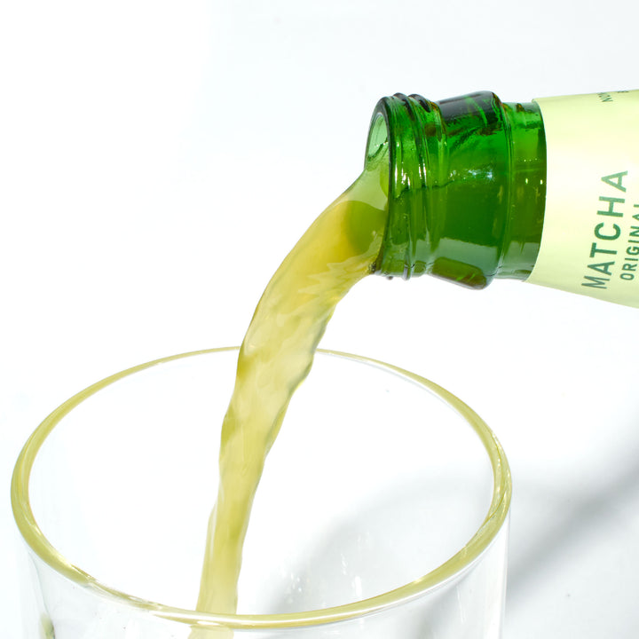 A bottle of Moshi Sparkling Uji Matcha: Original green tea being poured into a glass.