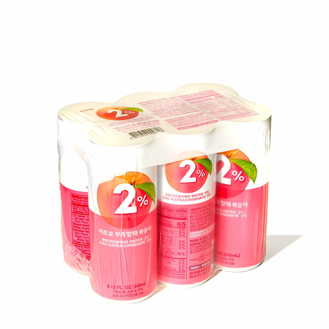 Four cans of Lotte 2% Water: Peach (6-pack) on a white background.