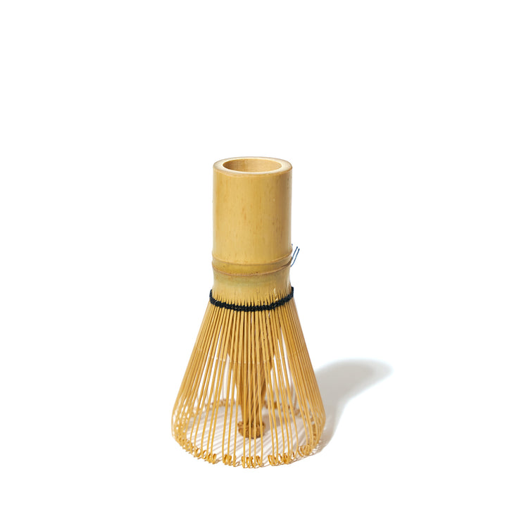 An Aiya Bamboo Whisk sitting on top of a white background.