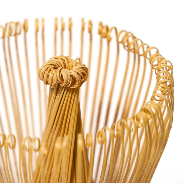 A close up of an Aiya Bamboo Whisk made of bamboo.