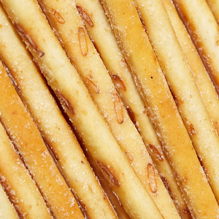 A close up of a bunch of Glico Pretz: Sour Cream & Onion sticks with sugar on them.