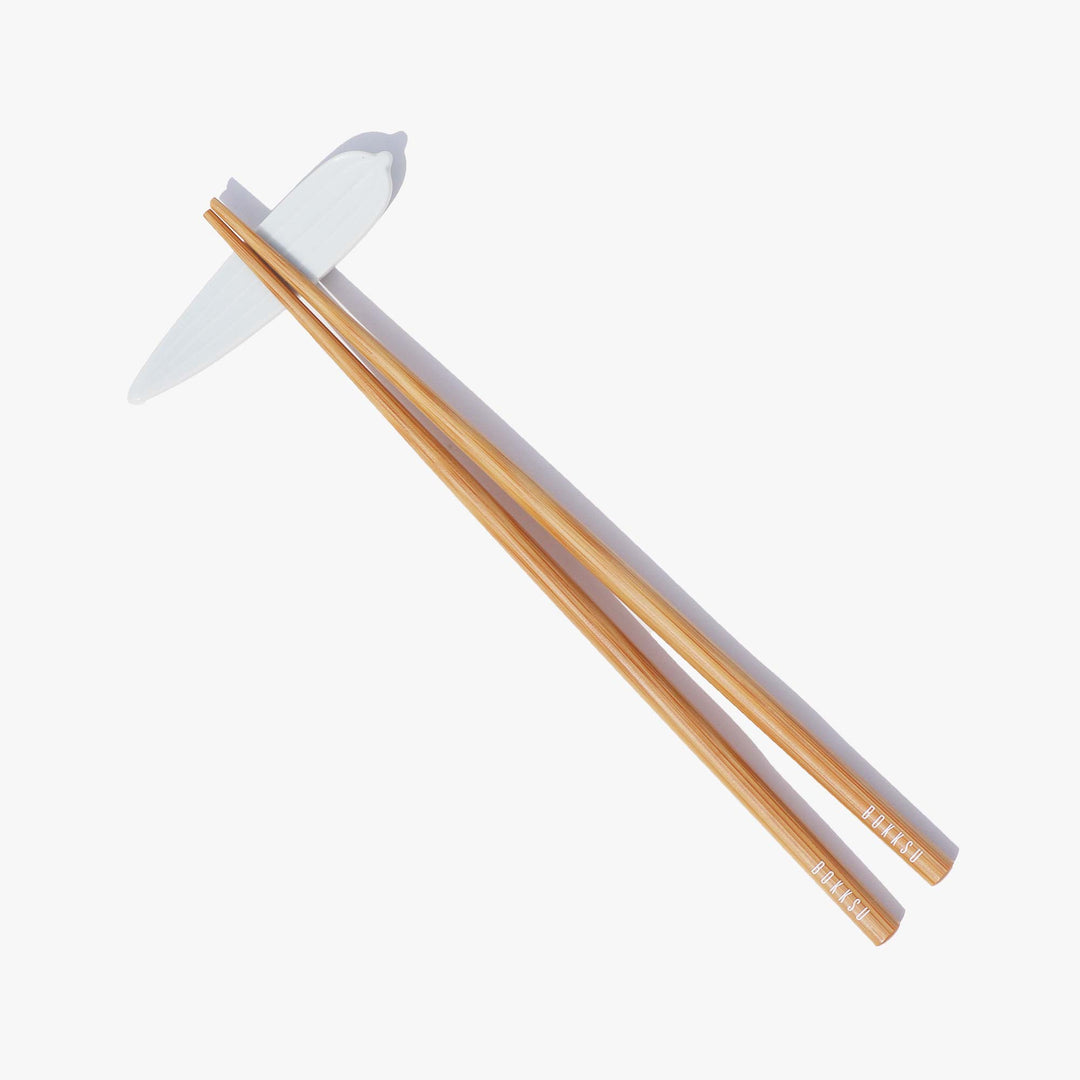 A pair of Bokksu Original Bamboo Chopsticks on a white surface.