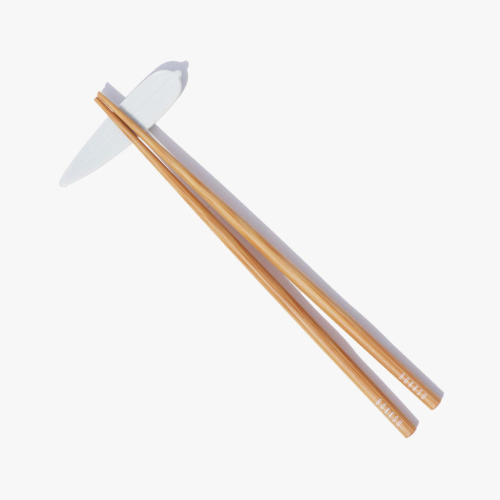 A pair of Bokksu Original Bamboo Chopsticks on a white surface.