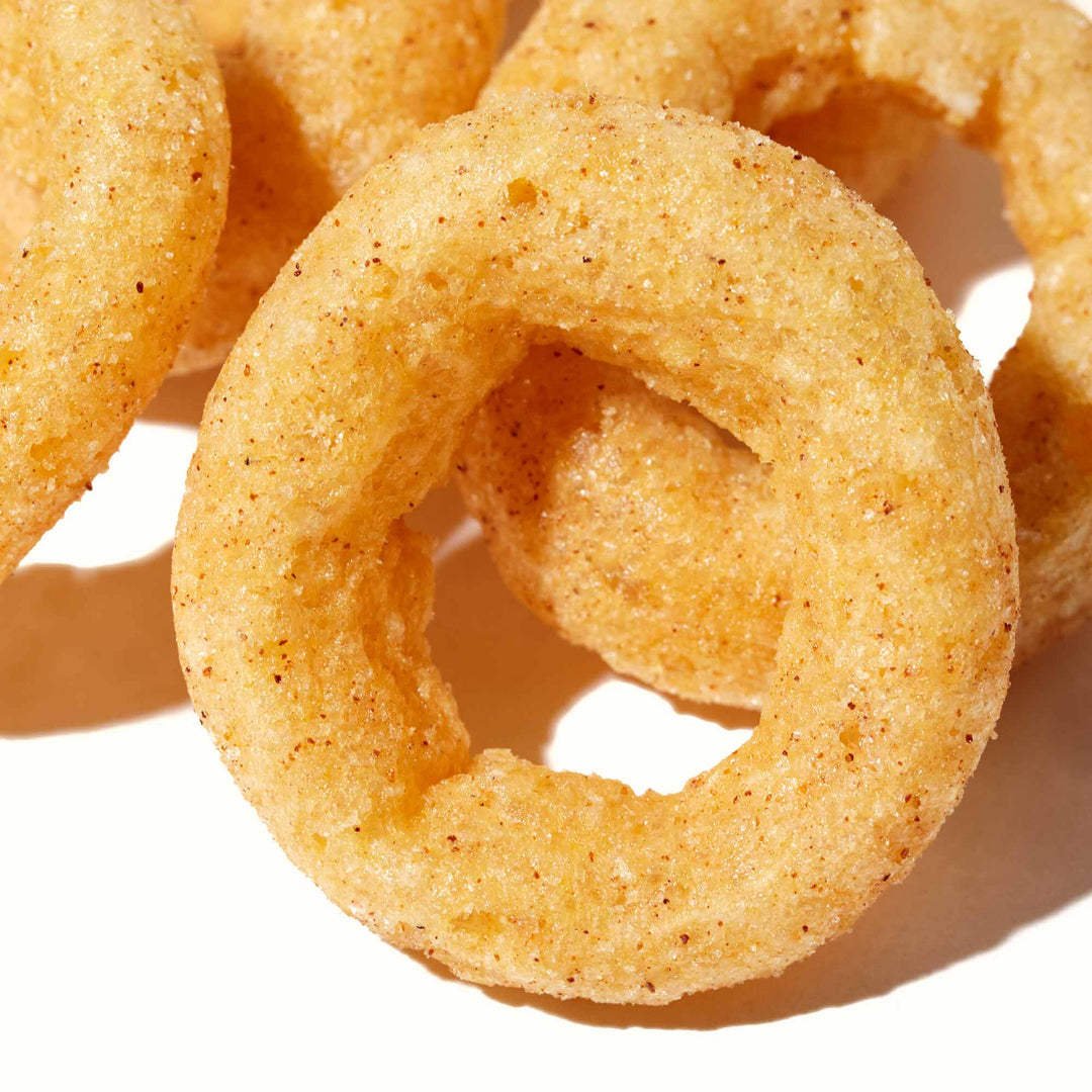 A group of Calbee onion rings on a white surface.