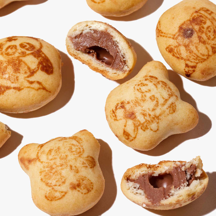 A group of Meiji Hello Panda: Chocolate cookies with drawings on them.