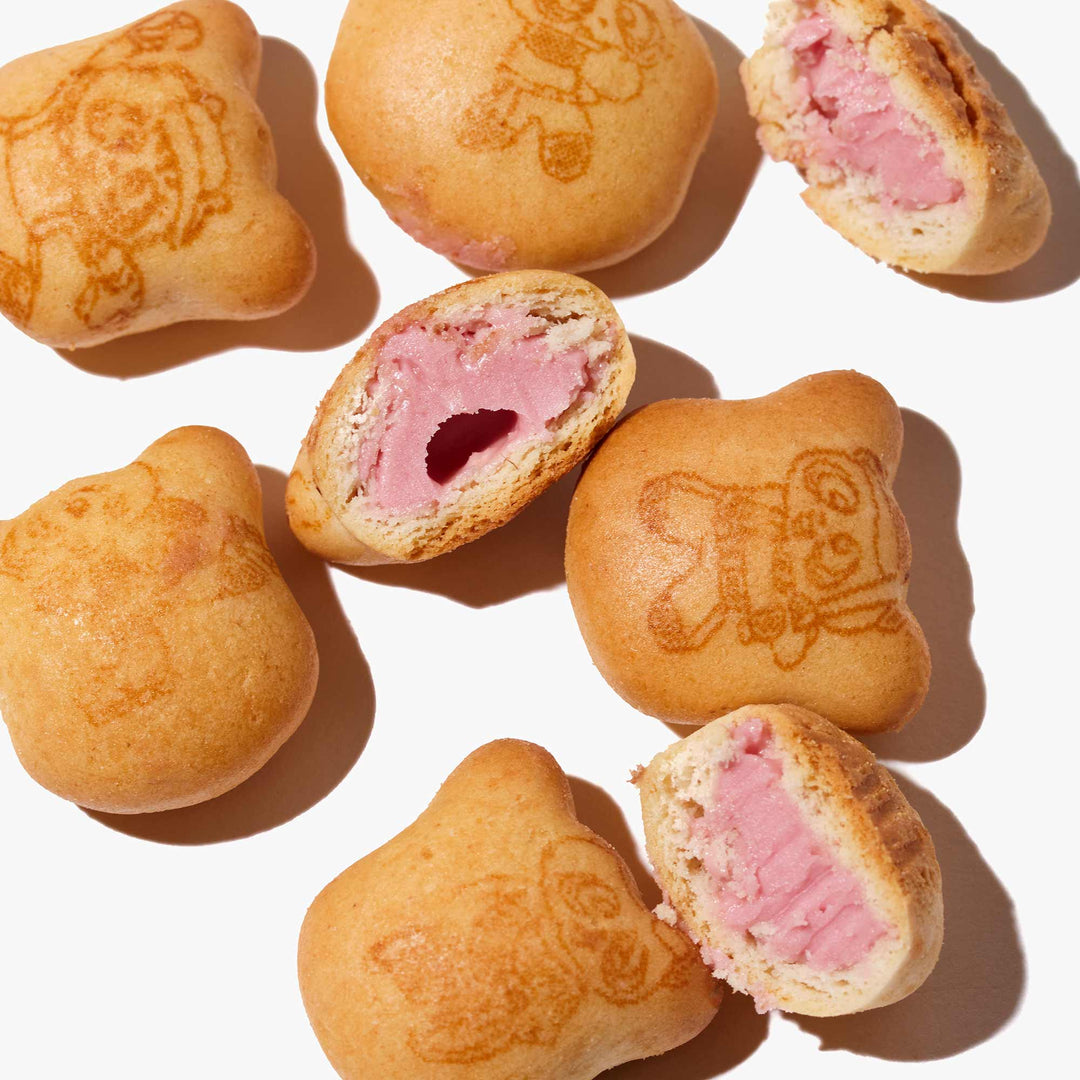 A group of Meiji Hello Panda: Strawberry pastries with drawings on them.