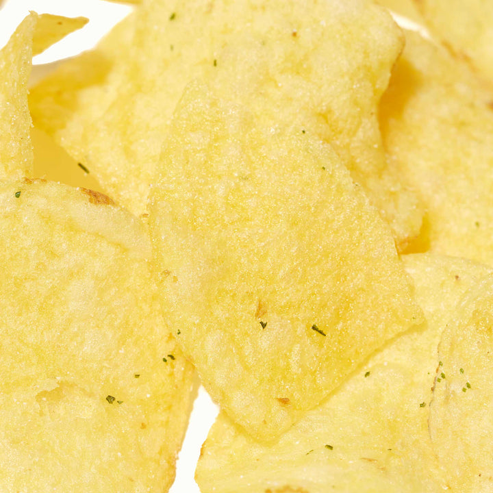 A pile of Calbee Potato Chips: Honey Butter on a white background.