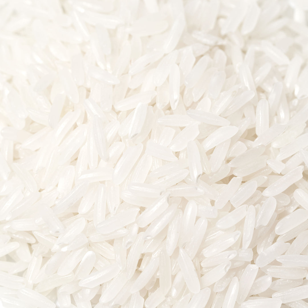 A pile of Dynasty Jasmine Rice: 2 lb on a white background.