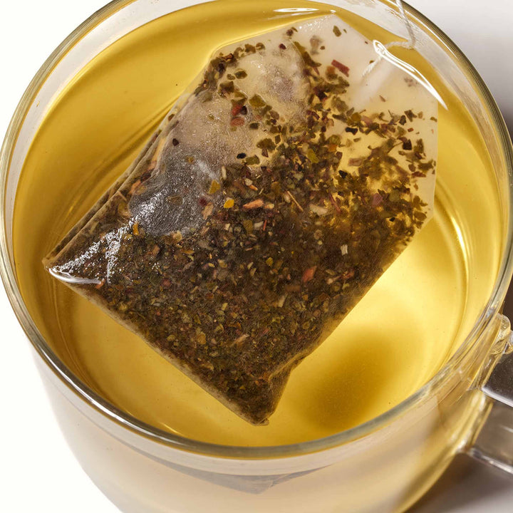 A Yamamotoyama Jasmine Tea bag in a cup of water.