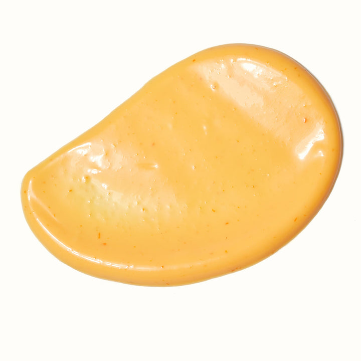 A close up image of Kikkoman Sriracha Mayo, a yellow liquid.