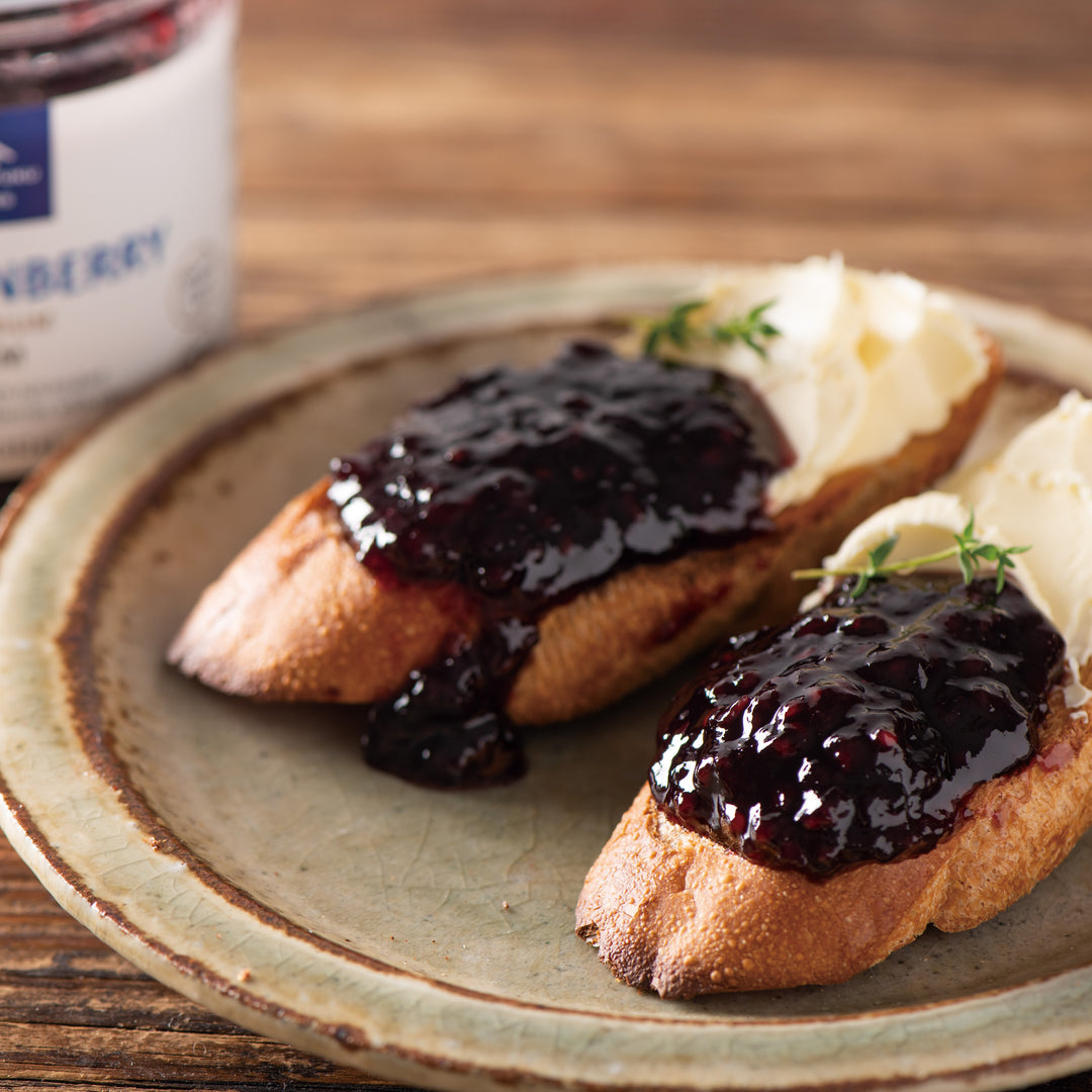 A plate with bread and Kuze Fuku Marionberry Jam from Kuze Fuku on it.