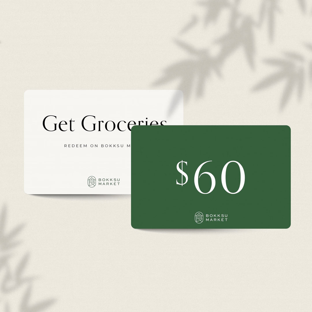 A Bokksu Market green gift card with the words get groceries.