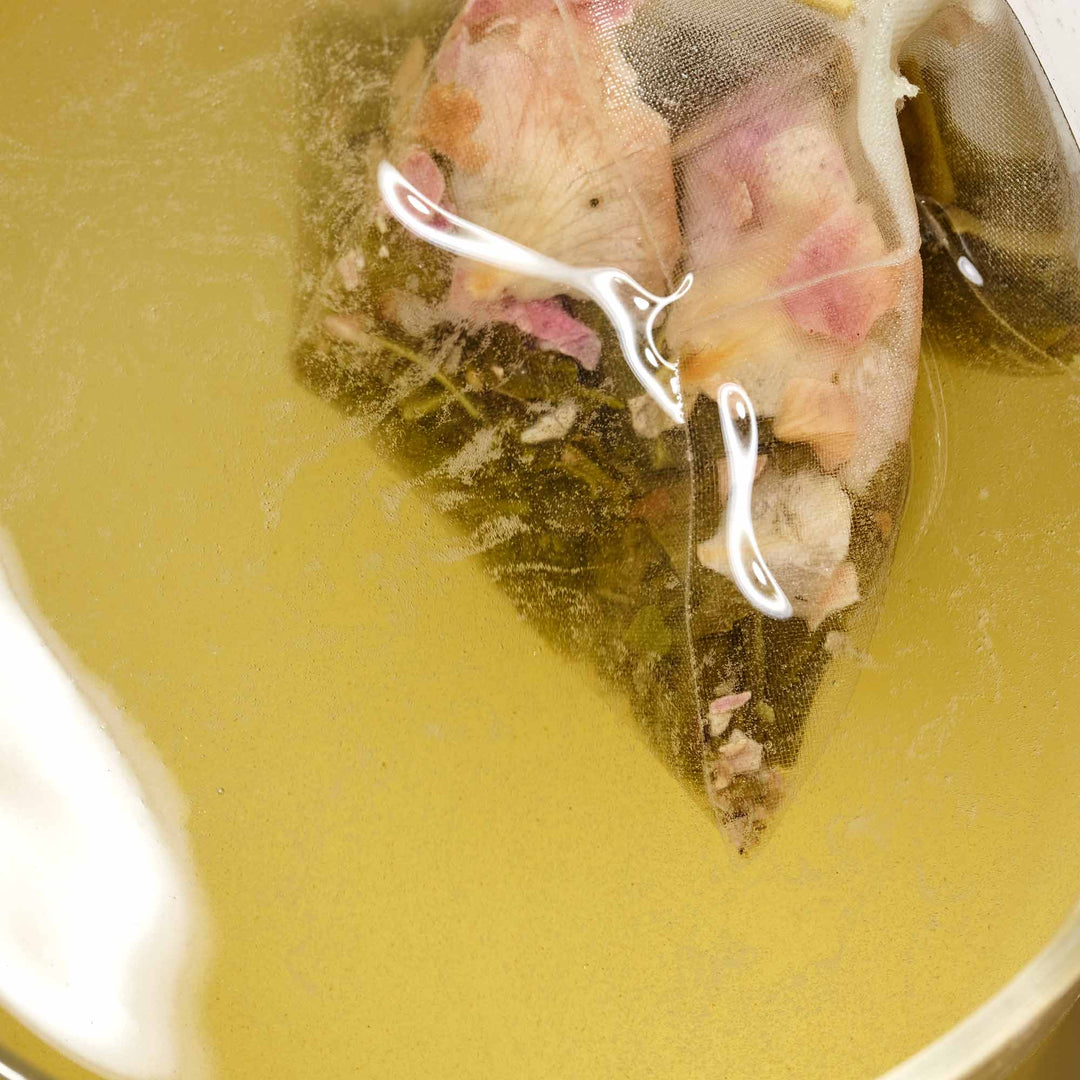 A Yamamotoyama tea bag filled with liquid and a piece of meat.