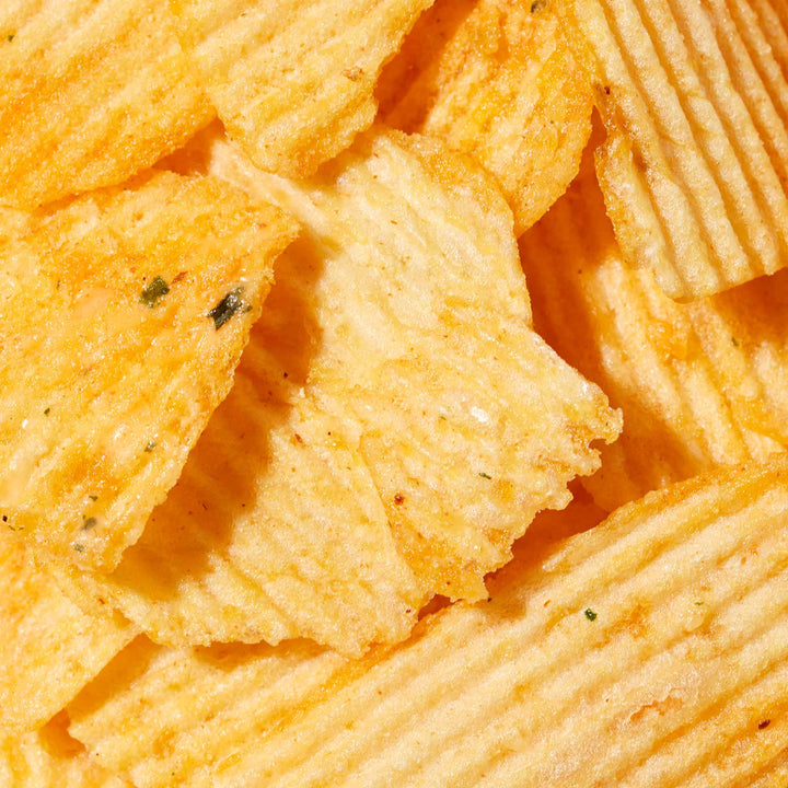 A close up of a pile of Calbee Potato Chips: Pizza.