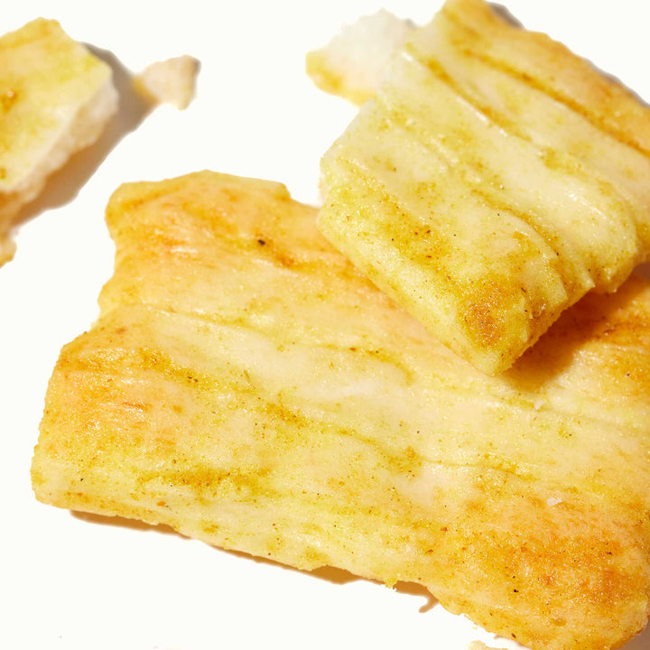 A Morihaku Cheese Curry Arare Crackers on a white surface.