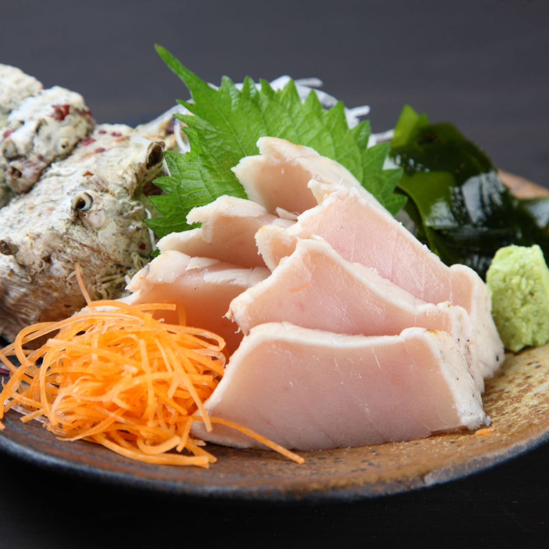 A plate with Sashimi-Grade Wild Albacore Tuna Loin (1 lb) from Kyokuyo and vegetables on it.