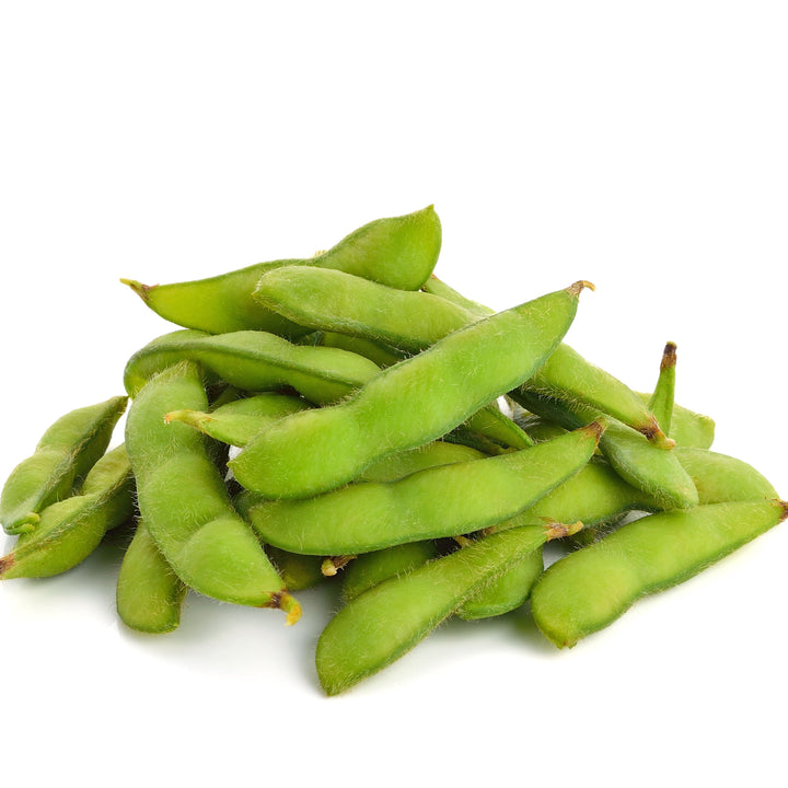 A pile of green Wel-Pac Salted Edamame on a white background.