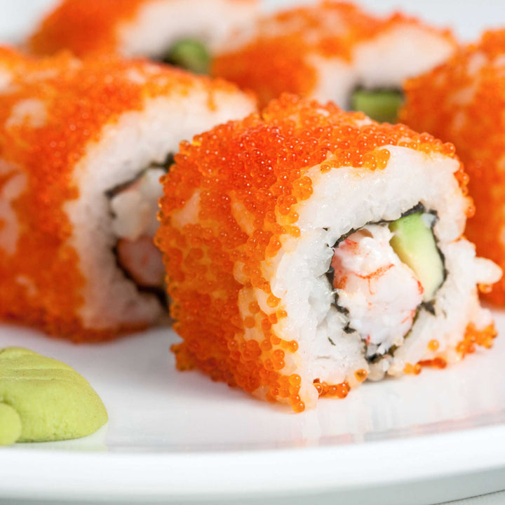 Kibun Kanikama Imitation Crab Stick rolls with shrimp and avocado on a white plate.