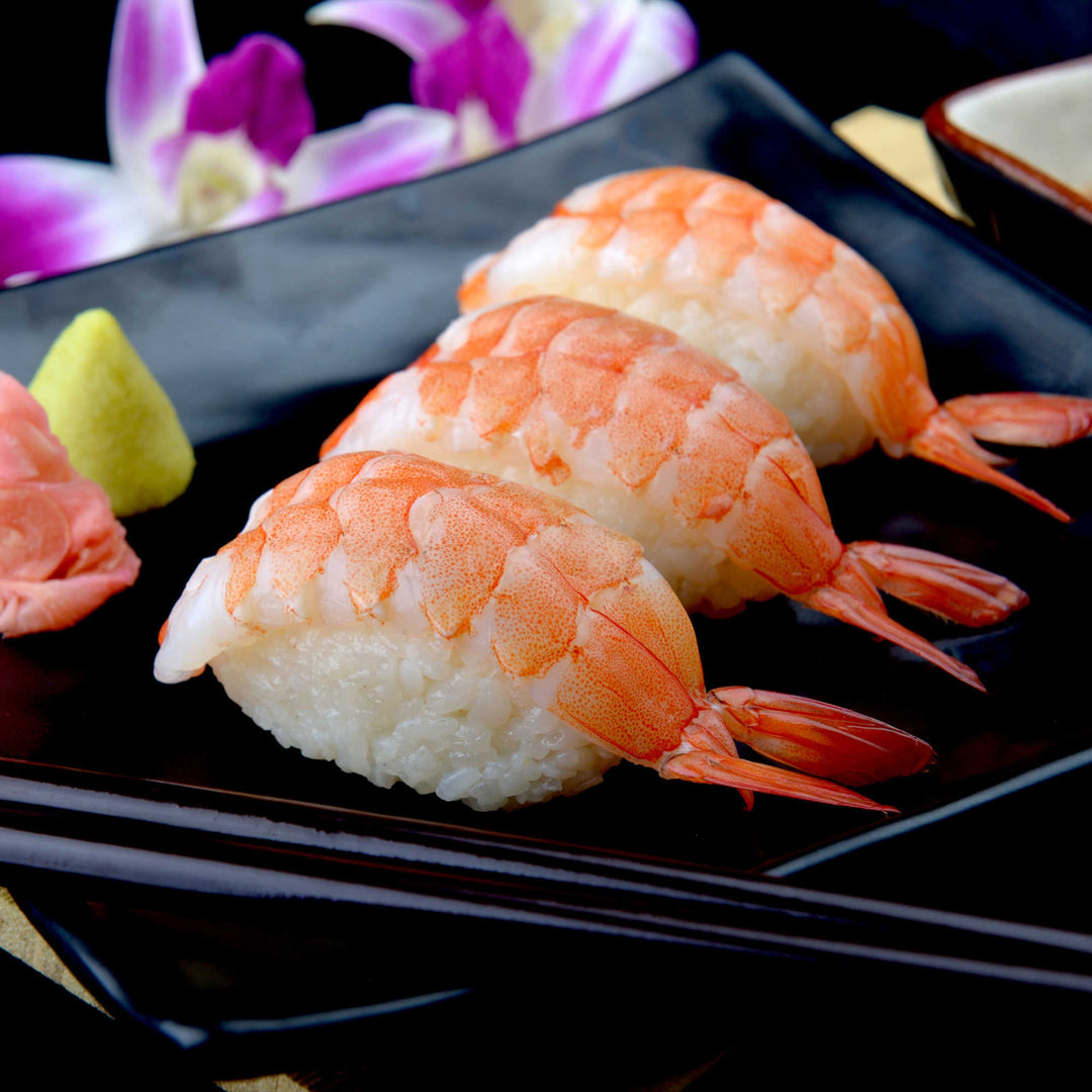 A plate of Amerin Boiled Sushi Shrimp (30 pieces) with chopsticks.