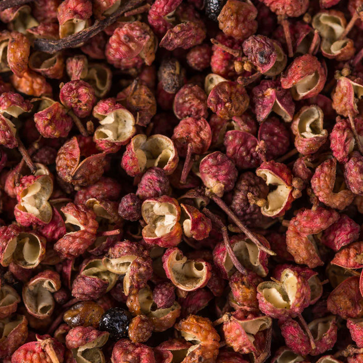 A close up image of a pile of dried Premium Hanyuan Sichuan Mala Peppercorn red berries by Hein.