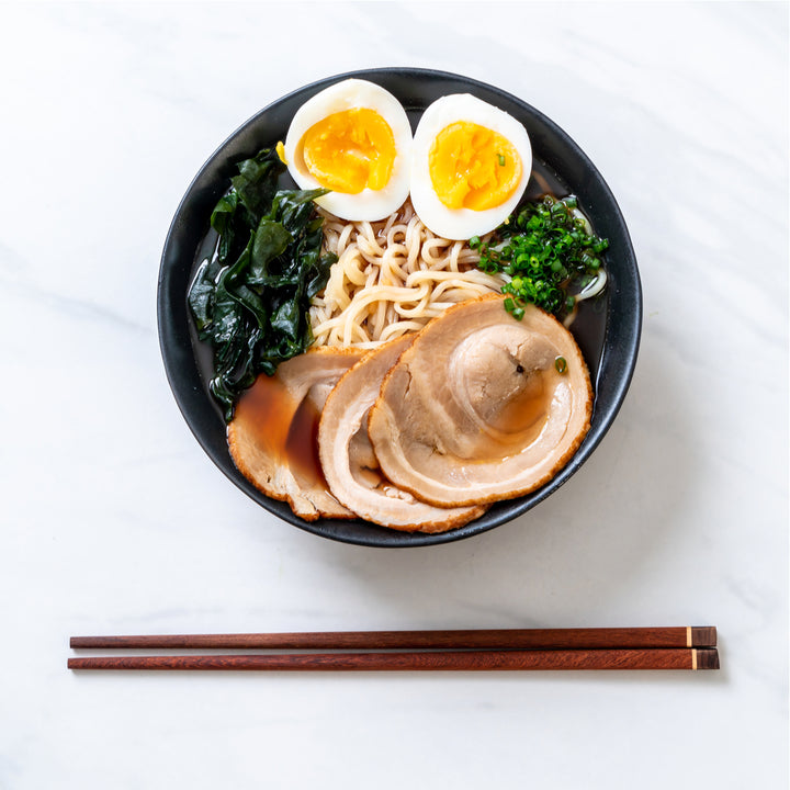 A bowl of Hakubaku Organic Ramen Noodles with an egg and greens.